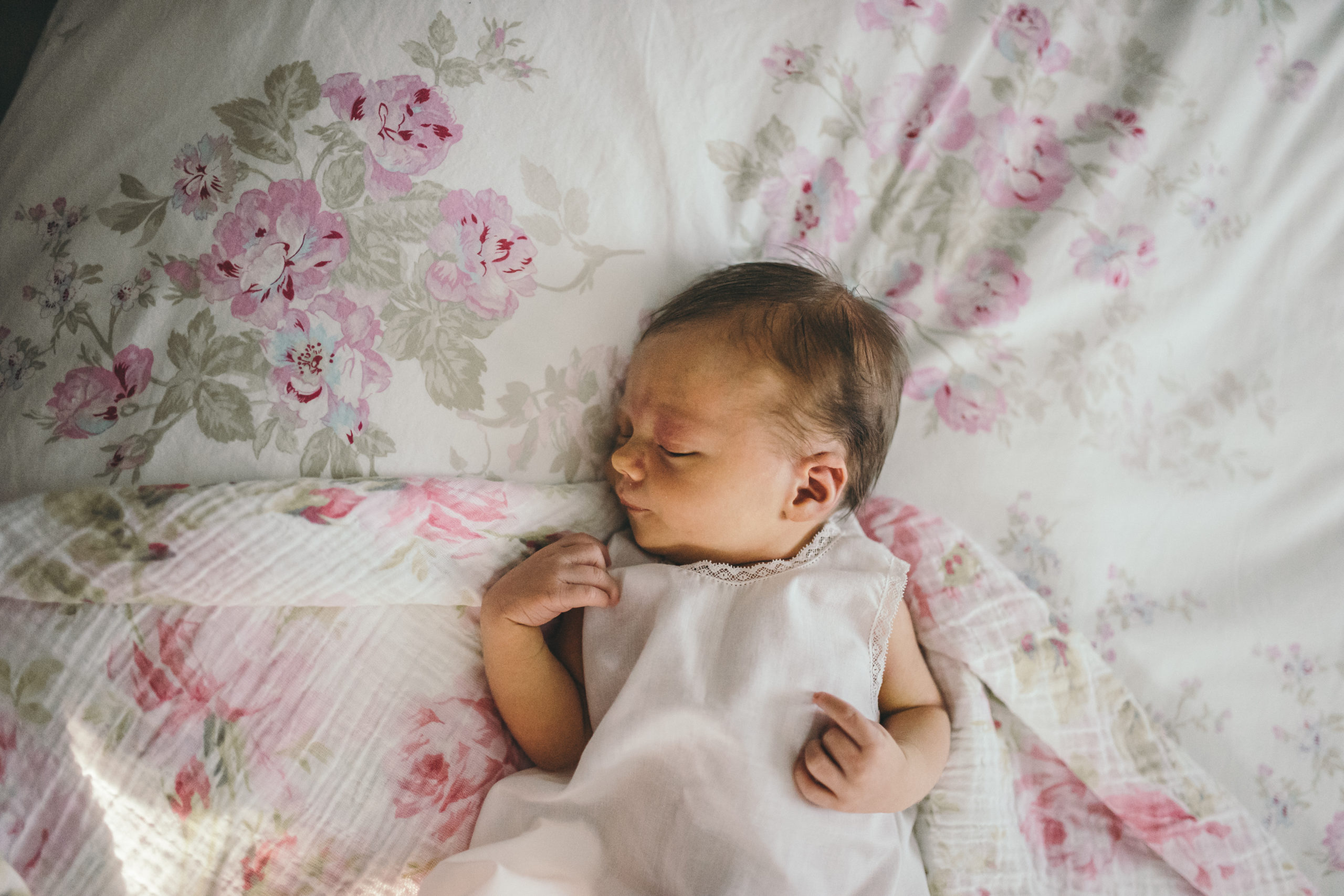 newborn baby girl on floral sheets
