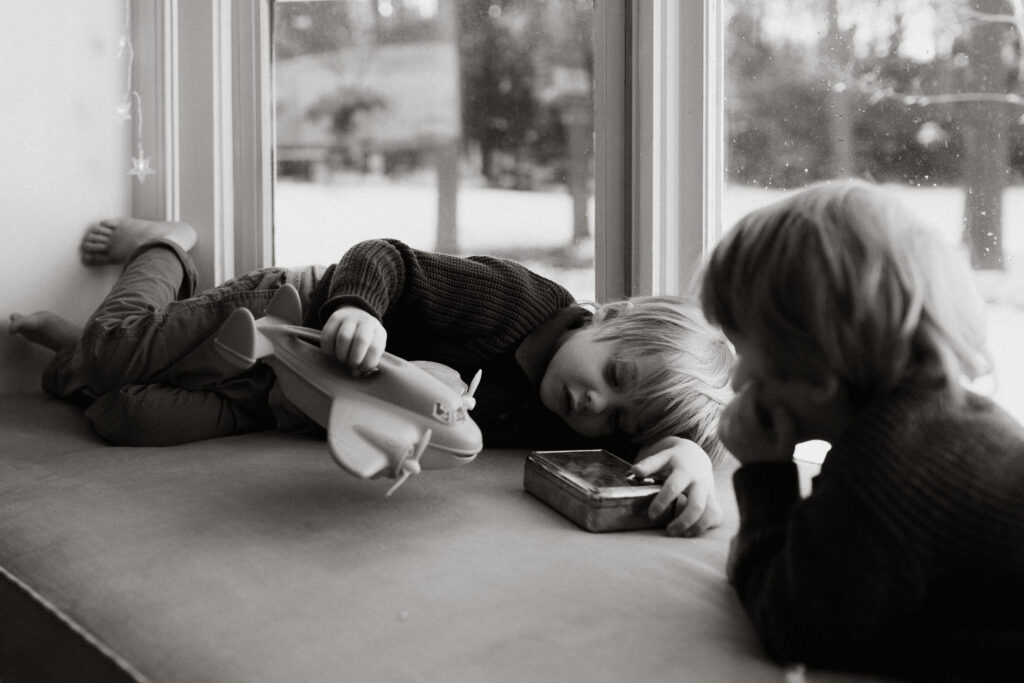 Boys play during family photos at home