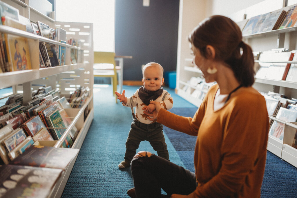 Mother and toddler son hang out in the library for family photo session. 