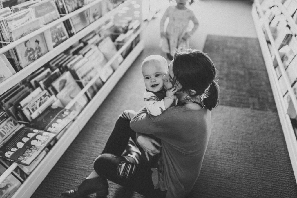 Mother and  kids hang out in the library as an example of family photo location ideas. 