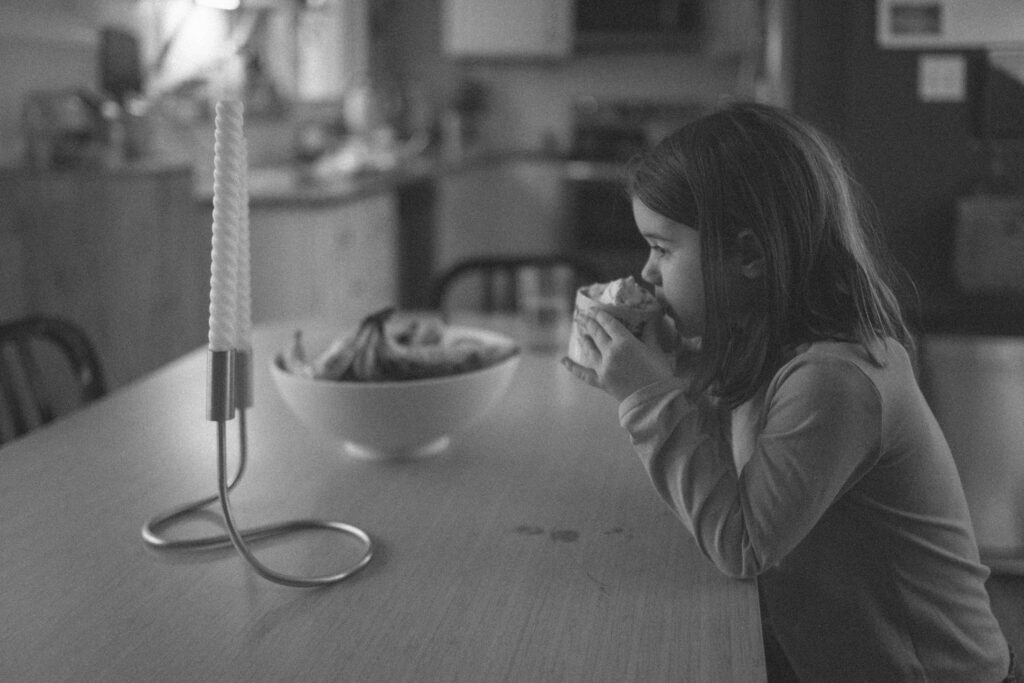 Young girl drinking hot chocolate as an example of snow photo ideas 