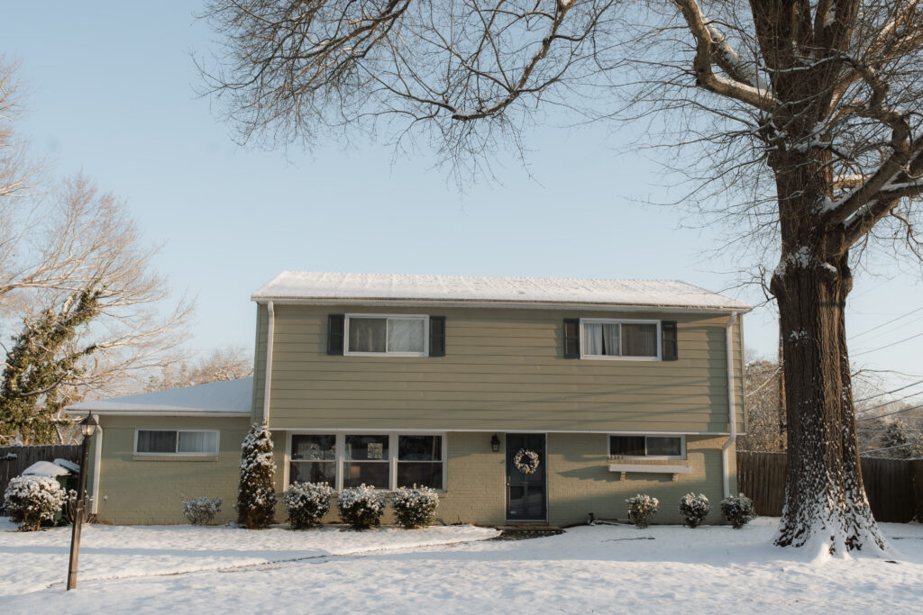 Suburban home covered in snow, as an example of snow photo ideas 