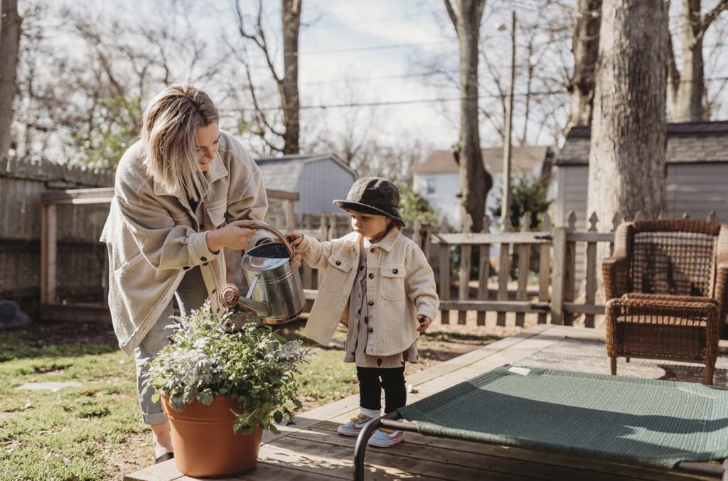 Mom and toddler daughter water flowers in spring photo session in Richmond, VA 