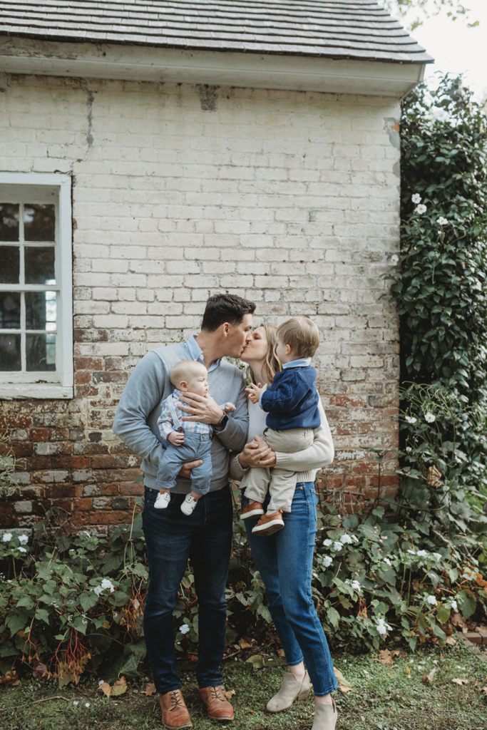 Couple kisses in spring family photo at Tuckahoe Plantation in Richmond, VA 