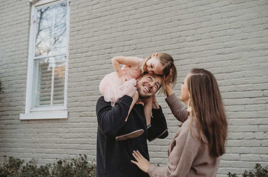 A family of three laughs in spring family photo in the Fan neighborhood of Richmond VA 