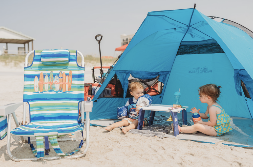 Two toddlers have a snack on Carolina Beach as an example of family photo location ideas. 