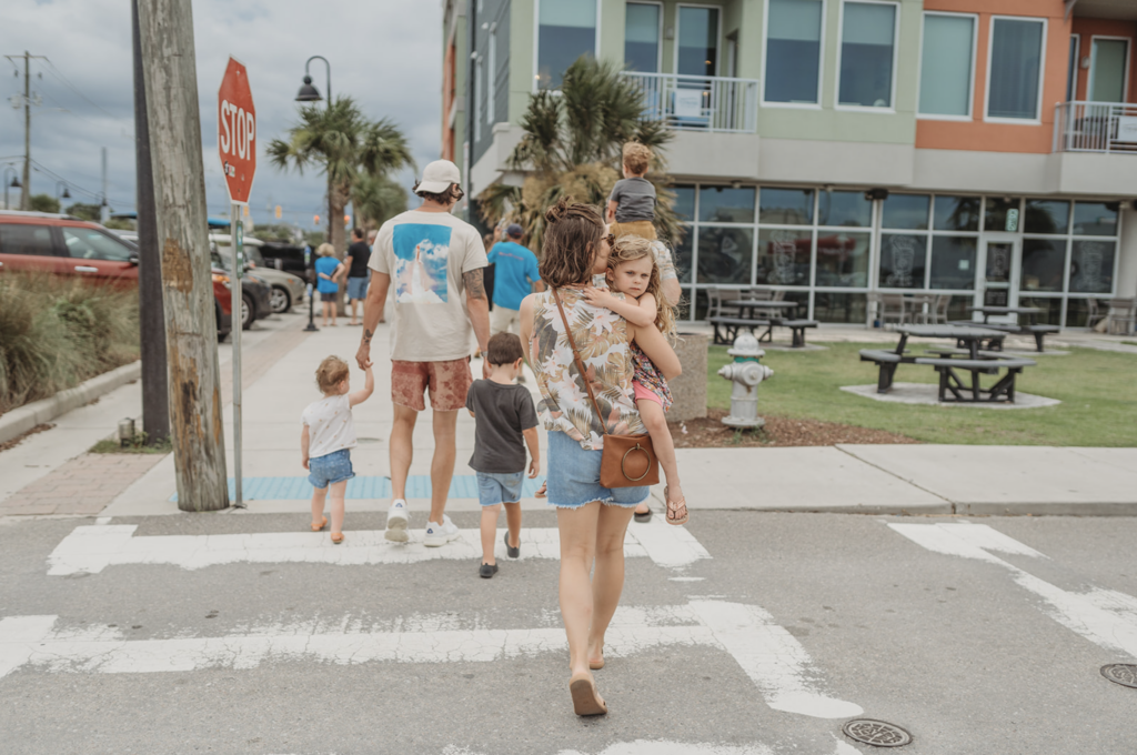 Mom and daughter walk around Carolina Beach as an example of family photo location ideas. 