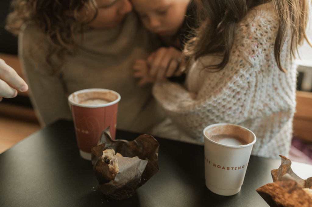 Family enjoys coffee and muffins at Blanchards Coffee in Richmond, VA as an example of family photo location ideas. 